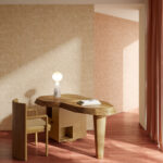 Werkkamer met Arte Essentials Brushed Suede behang in warme tinten, ingericht met een organisch gevormd houten bureau en bijpassende stoel.