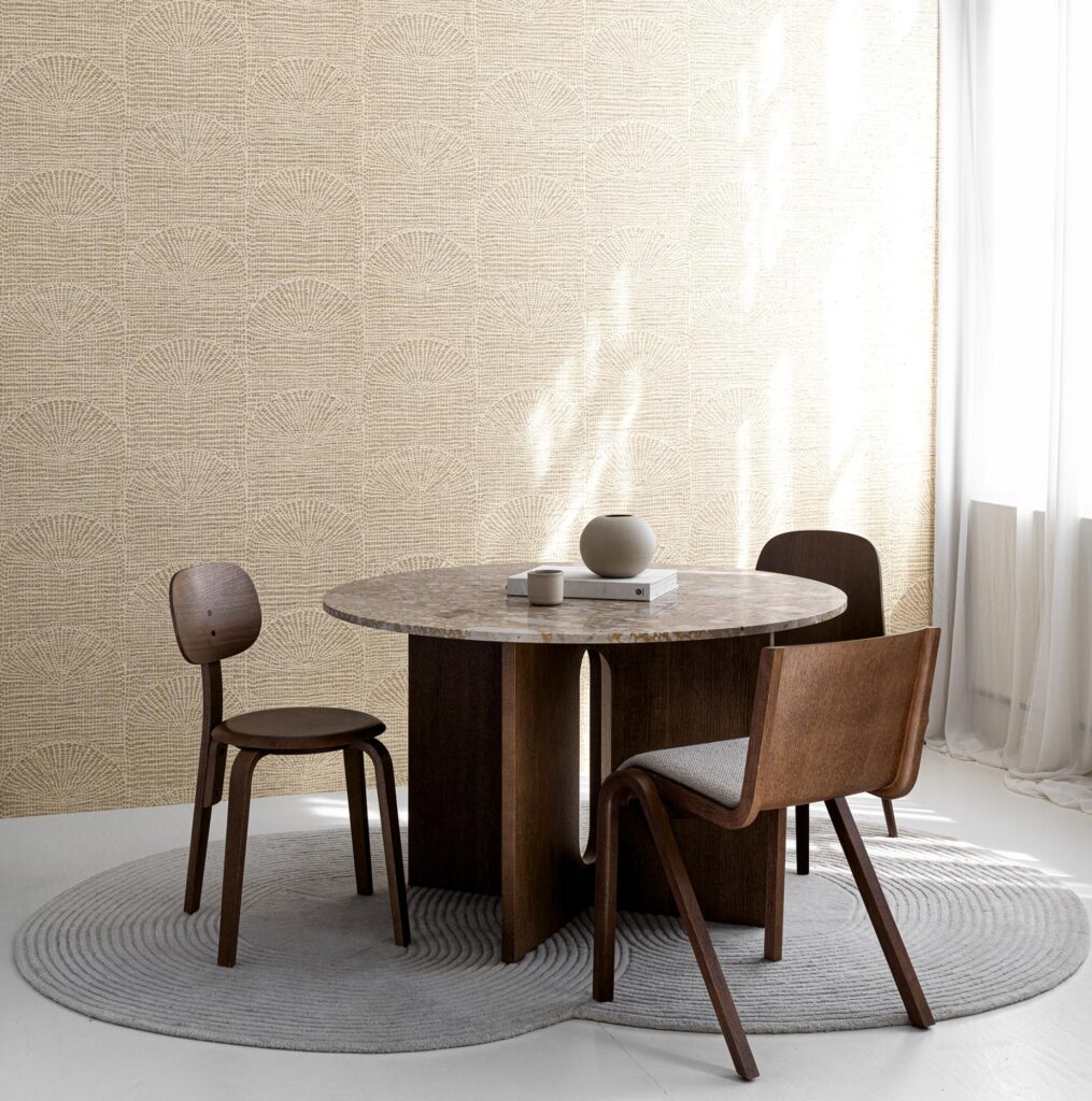 Moderne woonkamer met een ronde houten tafel, drie stoelen en Arte Pampas Cupula behang op de achtergrond.