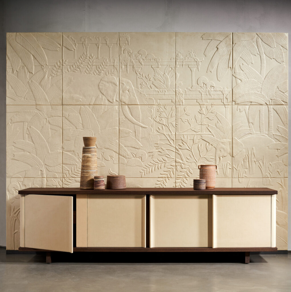 Luxe interieur met Arte-behang Babylon Between Rivers 97003 met reliëf van jungle en olifanten, achter een modern dressoir met aardetinten.