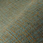 Detailopname van het Arte Nongo behang uit de Gitane collectie met een geweven textuur in blauw- en aardetinten.