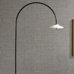 Booglamp met witte kap voor een muur bekleed met Arte behang Textura Puro 27009A.