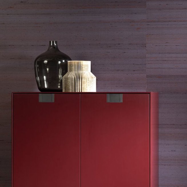 Dieprode kast met decoratieve vazen ervoor geplaatst tegen paarse Kami Dupion-behang van Arte.