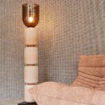 Beige loungezetel en decoratieve vloerlamp voor een muur met Arte Waffle Weave behang.