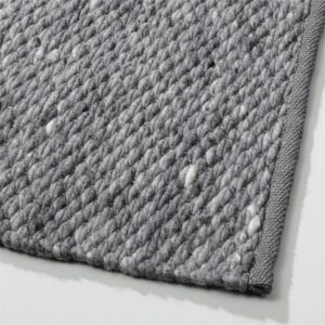 Grijs Perletta Finesse vloerkleed met grove, geweven textuur en afgebiesde rand.