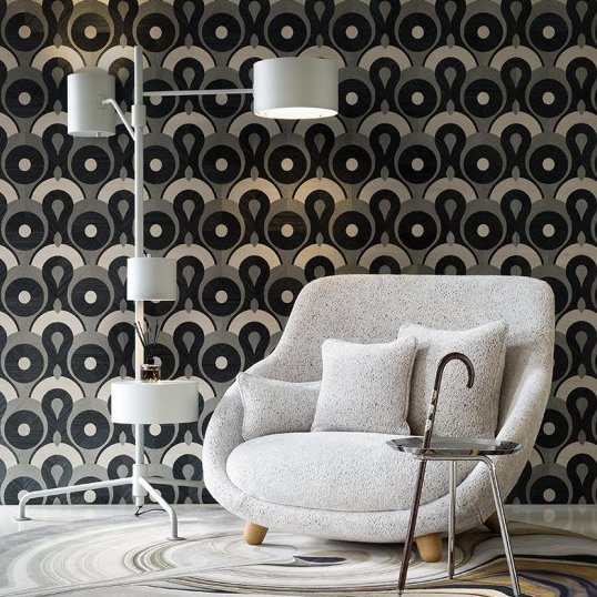 Moderne zithoek met de Arte Moooi Queen Cobra behang, een witte designstoel, vloerlamp en bijzettafel.