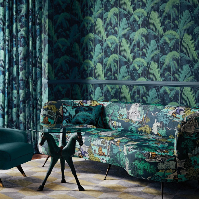 Woonkamer met Cole and Son Palm Jungle behang, bijpassende gordijnen en een kleurrijke jungleprint bank.