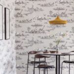 Behang met zwart-witte tekeningen van Afrikaanse dieren in boten uit de Cole and Son Ardmore Zambezi collectie, in een modern ingerichte eetkamer.
