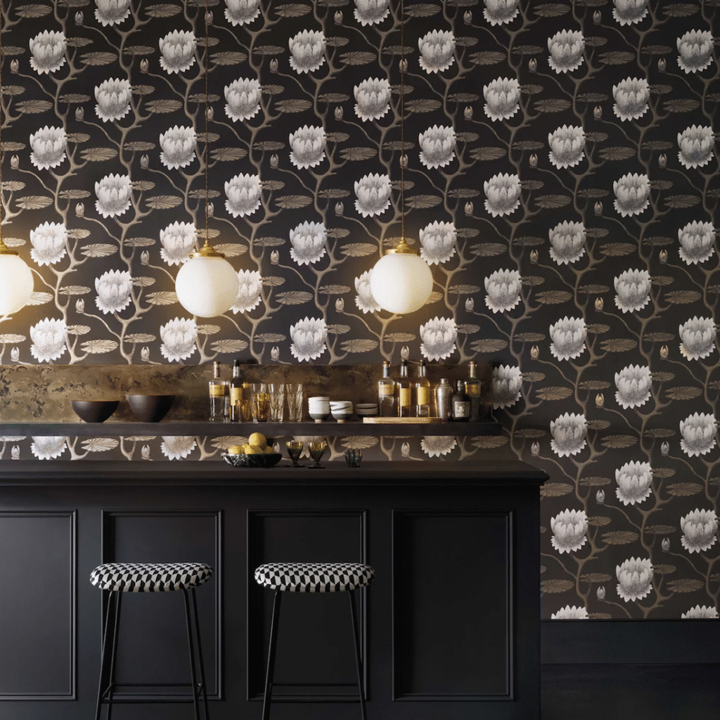 Luxe interieur met donker Cole and Son Summer Lily-behang, zwarte bar en sfeerverlichting.