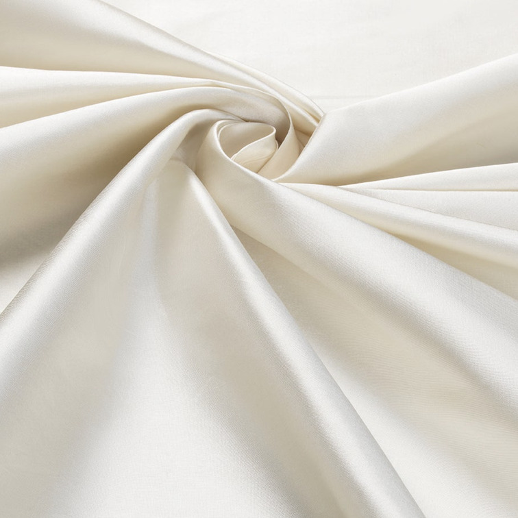 Detailopname van een glanzende, ivoorwitte zijden stof uit de Cole & Son Colour Box-collectie.