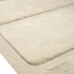 Detailopname van het Elitis Alaska TA 125 03 02 vloerkleed met een zachte, beige textuur en verhoogde structuur.