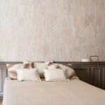 Smaakvol ingerichte slaapkamer met Elitis Ecrin Blanche Neige RM 972 01 behang in zachte beige tinten.