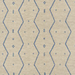 Beige Elitis Tampico-stof met een zigzagpatroon en blauwe geometrische motieven.
