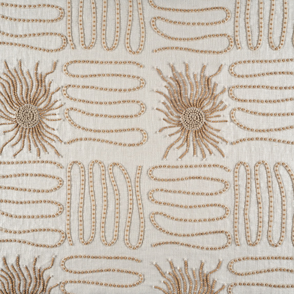 Geborduurd textielpatroon Elitis Baleares Paloma LZ 898 01 met zonvormige en golvende lijnen in beige en bruin op een lichte achtergrond.