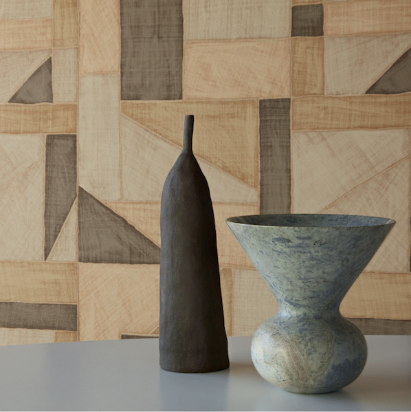 Twee keramische vazen voor een Elitis La Caravane Kungbo VP 944 behang met geometrisch patroon in aardetinten.