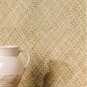 Een beige vaas staat voor een wand met Elitis Buri behang van gevlochten natuurlijke vezels in een geometrisch patroon.