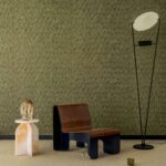 Stijlvolle interieurhoek met Elitis Cordes Sensibles Jonchée behang, designstoel, marmeren bijzettafel en moderne vloerlamp.