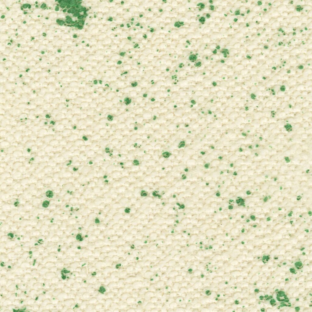 Close-up van de Elitis Excentric Jacky stof in beige met groene spikkels.