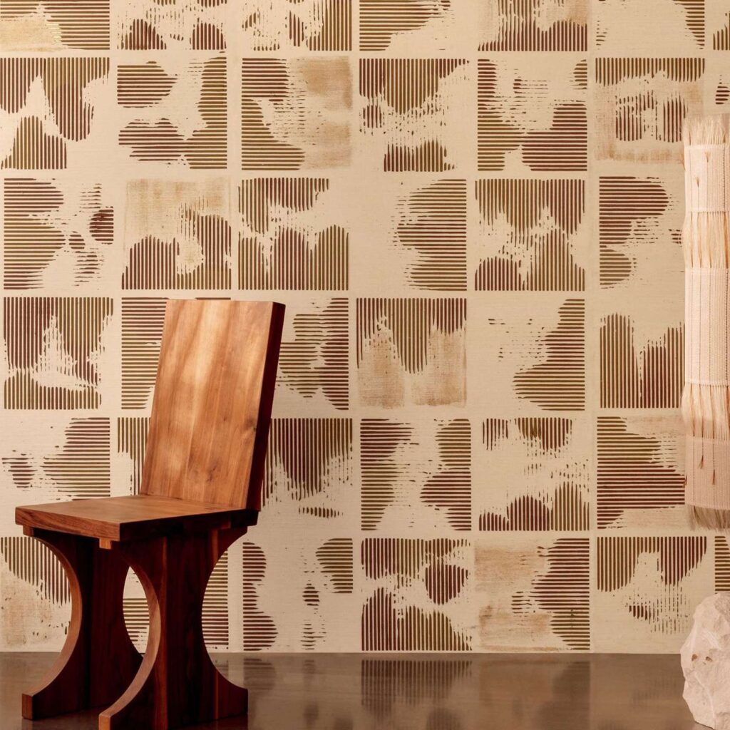 Houten designstoel voor een muur met Elitis Maestria Kalliste RM 1077 02 behang in abstract vierkantenpatroon.