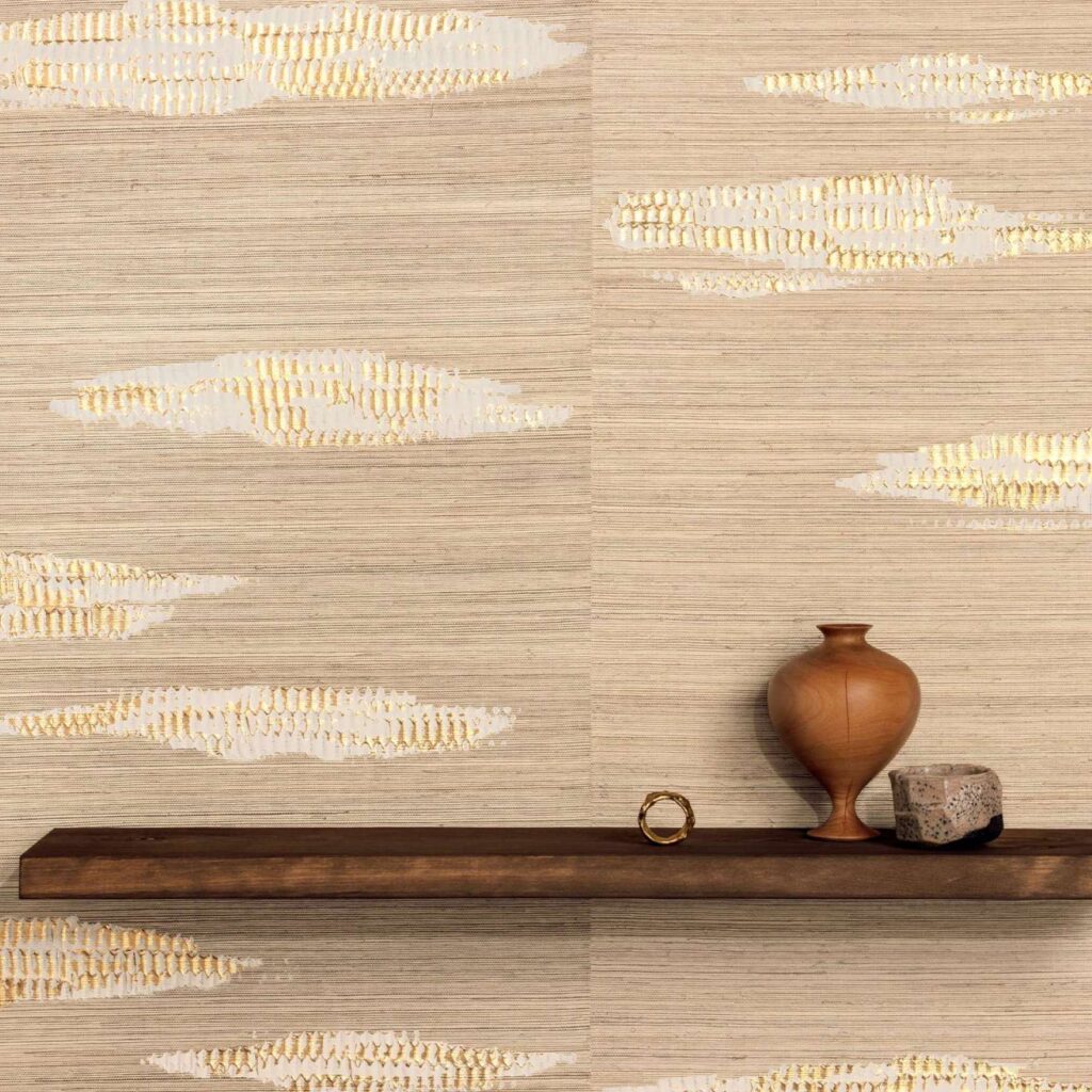Decoratieve Elitis Maestria Orion RM 1075 80 crèmekleurige wandbekleding met goudaccenten, met een houten plank en aardewerken objecten.