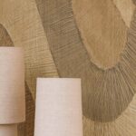 Beige lampenkappen voor een Elitis Pignada behang met houtsculptuurlook in abstract patroon.
