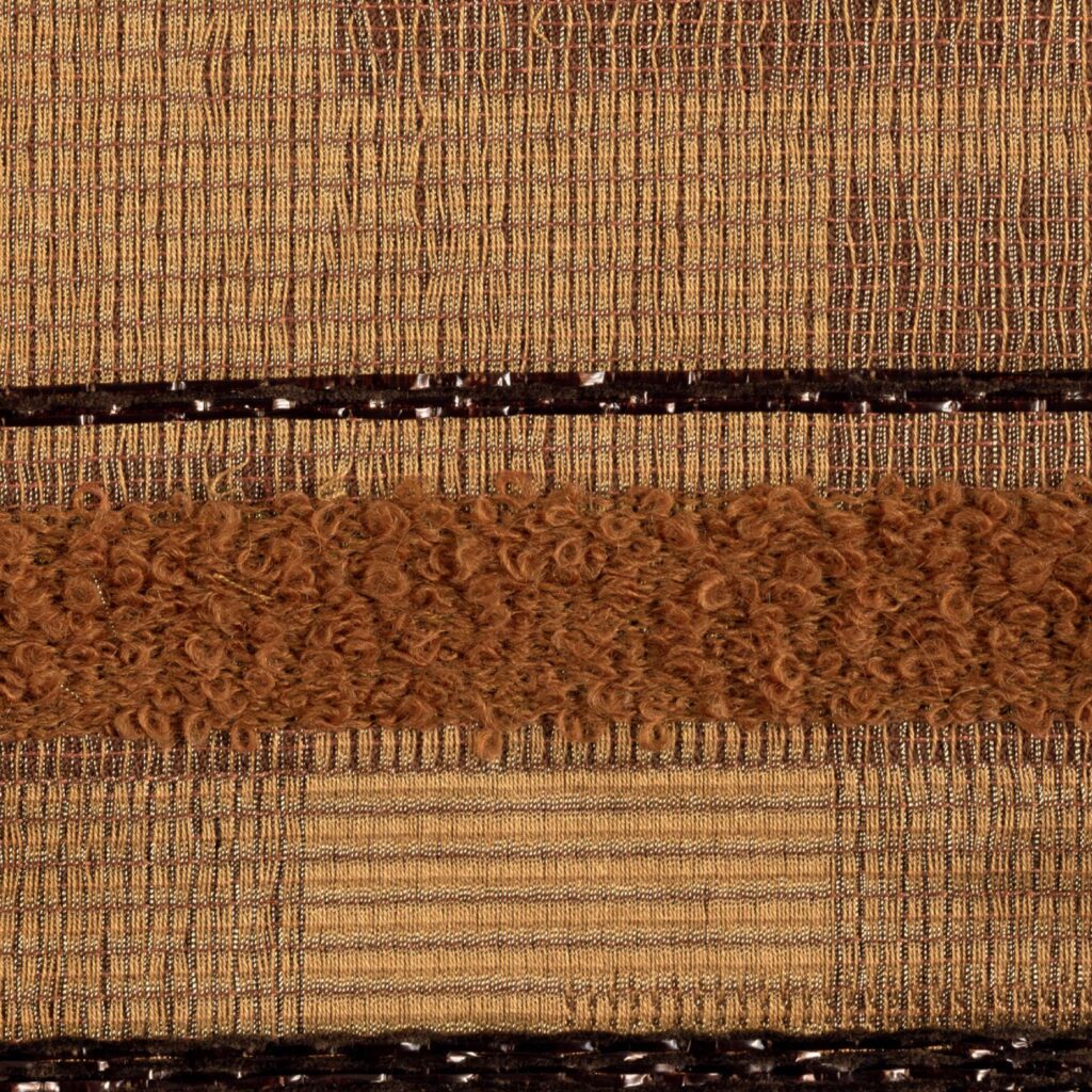 Detailopname van de Elitis-stof Craft Chic Regina LR 335 24 met een combinatie van geweven en lusvormige texturen in warme bruintinten.