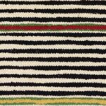 Gestreepte Elitis-stof Escondido LR 357 80 met afwisselende zwarte, witte, rode, groene en gele banen in een geweven textuur.