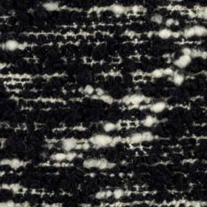 Detailopname van de Elitis-stof Horizon LI 876 80 met een grof geweven zwart-wit textuur.