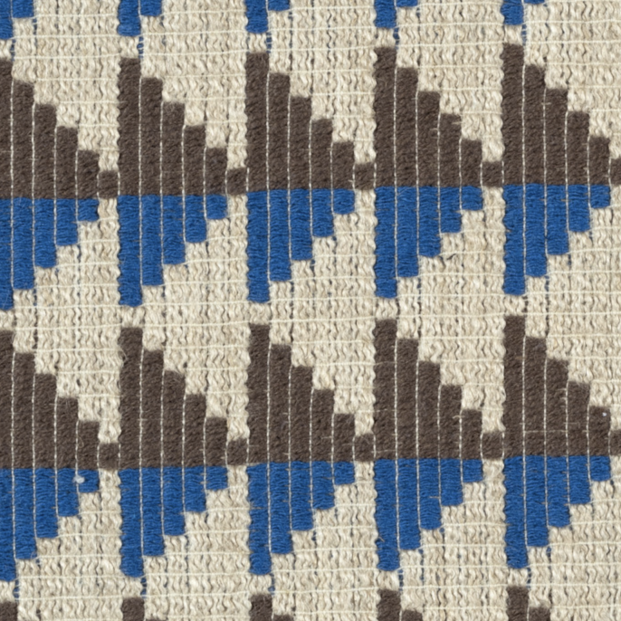 Detail van Elitis-stof Horizon LI 882 41 met geometrisch patroon in beige, bruin en blauw.