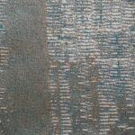 Close-up van Eltis-stof in het dessin Craft Chic Sera LR 336-76 met een blauw-grijs gemêleerd patroon.