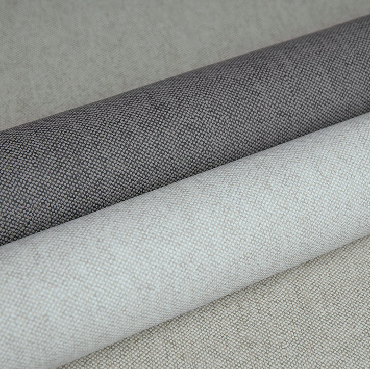 Drie opgerolde stoffen uit de LesUnis3-F4MV collectie in grijze en beige tinten met een fijne geweven structuur.