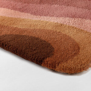 Detail van het Limited Edition Allegro Low Aprico Brandy tapijt met golvende patronen in warme bruintinten en roze.