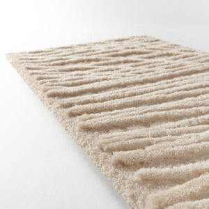 Detailopname van het Limited Edition vloerkleed Spiro Summer Sand met reliëfstructuur in zandkleurige tinten.