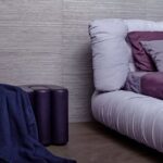 Modern interieur met een lila bank, paarse accenten en Line behang van Arte op de muur.