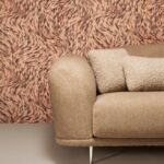 Beige bank voor een muur met het roze-bruine Moooi-behang Blushing Sloth met abstract patroon.