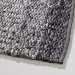 Close-up van een Perletta Limone Fade Grey vloerkleed met grove, grijs verloop geweven structuur.