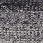 Close-up van het Perletta Limone Fade Grey vloerkleed met een gevlochten textuur in grijstinten.