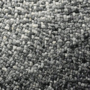 Detailopname van het grijs verlopende, handgeweven oppervlak van het Perletta Roundabout Fade Grey vloerkleed.