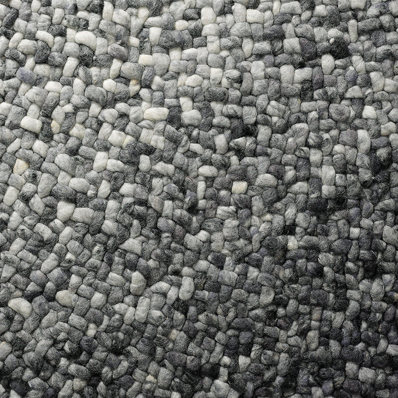 Detailopname van het grijs verlopende, handgeweven oppervlak van het Perletta Roundabout Fade Grey vloerkleed.