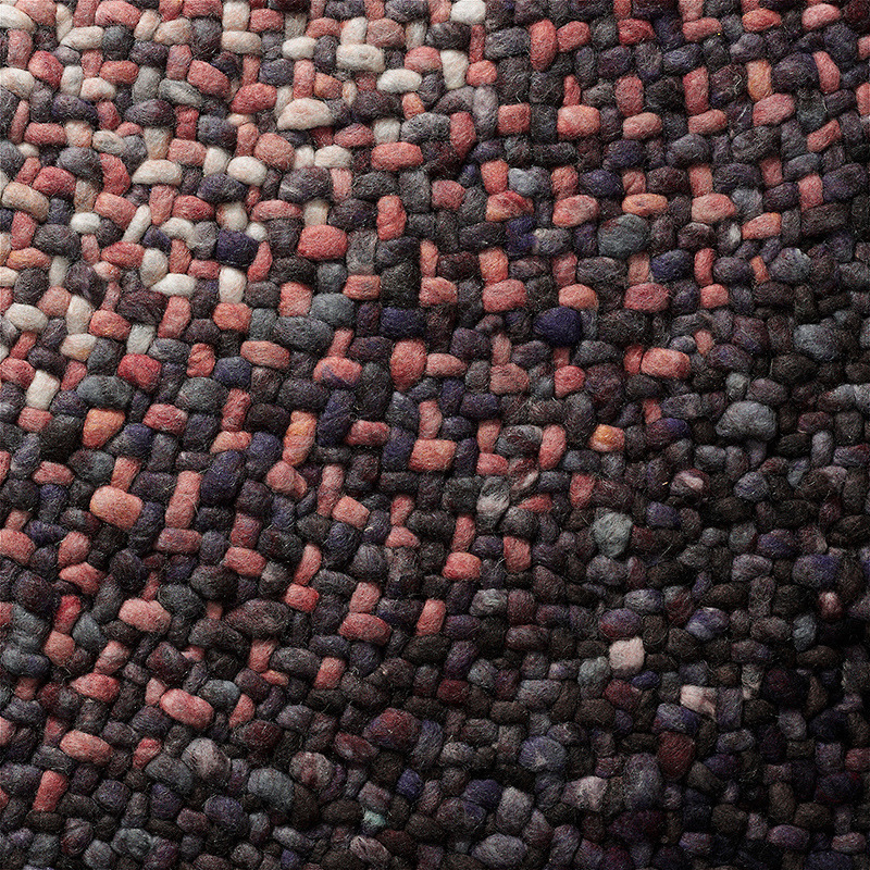 Detailopname van het geweven oppervlak van het Perletta Roundabout Fade Purple vloerkleed met een mix van paarse, grijze en roze tinten.