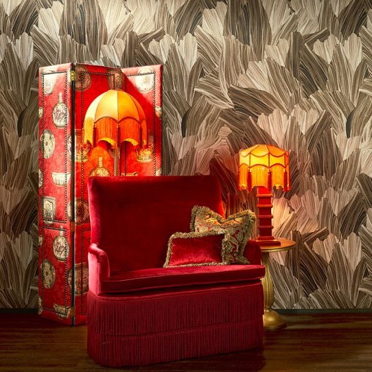 Rode fauteuil met vintage lampen en decoratief Arte Pavartina 97560 behang op de achtergrond.
