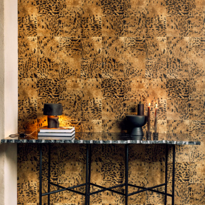 Marmeren consoletafel met decoratieve objecten tegen een goudbruine Elitis Sauvages VP 653 07 behangwand met dierenprintmotief.