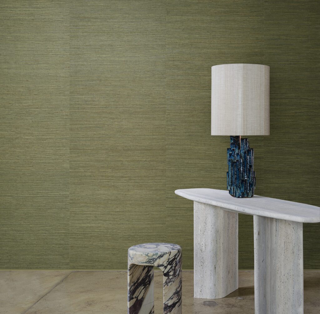 Interieur met groene Arte Prismatic Gradient 52405 wandbekleding, een marmeren bijzettafel, gekleurde kruk en een opvallende lamp.