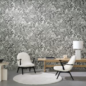 Moderne zithoek met twee witte fauteuils, een houten tafel en Arte Sierra Nevada 97760 behang met grafisch zwart-wit bergpatroon.