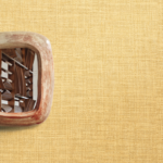 Muur met Geel Madagascar behang van Elitis, behang met een fijne structuur